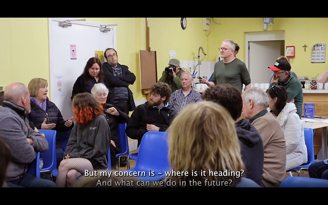 Image Credit: Stigma Damages, 2011-ongoing, video, 22 mins. Video sceenshot of artist Michele Horrigan in an organised public meeting in nearby Askeaton. Courtesy of the artist.